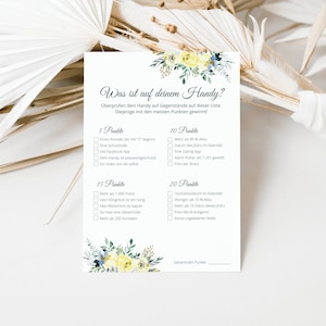 May include: A printable game card with a floral design and the text "Was ist auf deinem Handy?" (What's on your phone?). The card has a list of items to check on a phone, with points assigned to each item.