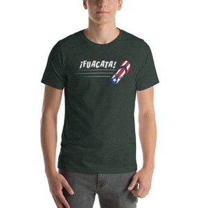 May include: A dark green t-shirt with a white graphic of a flip-flop with the Puerto Rican flag colors and the text "&iexcl;FUACATA!"