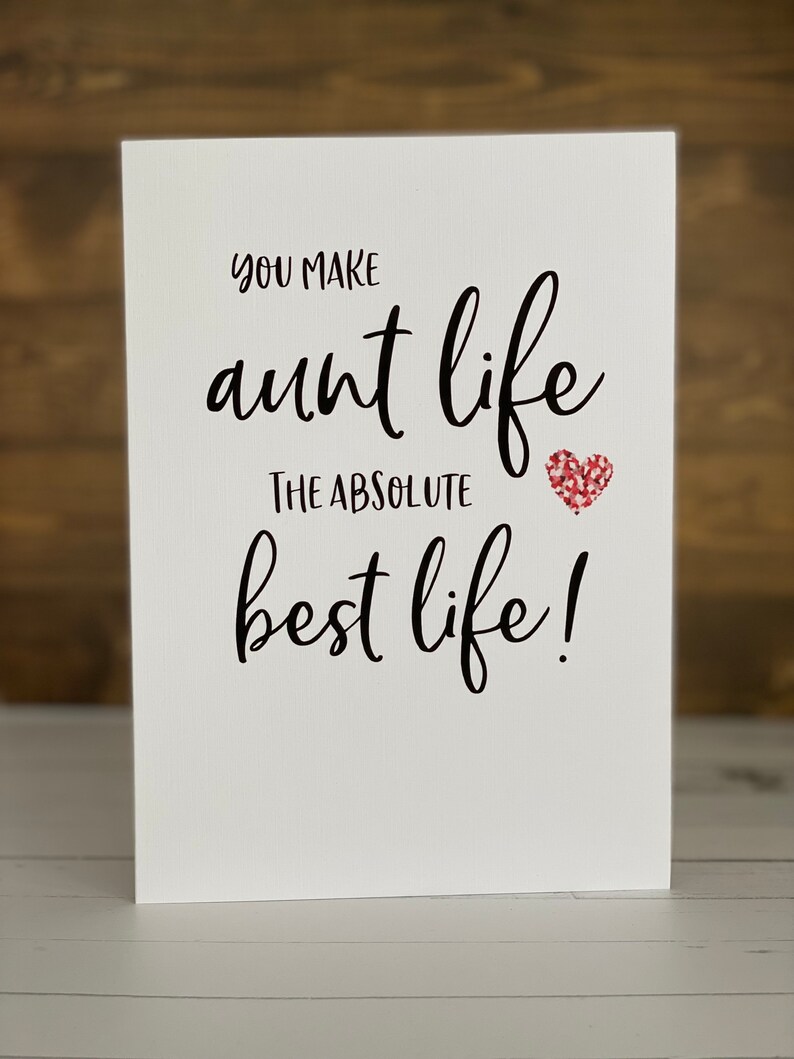May include: White card with black text that reads "You make aunt life the absolute best life!" with a red glitter heart.