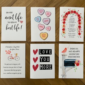 May include: Six different Valentine's Day cards with various designs and messages. The cards feature hearts, flowers, a bicycle, a bird, and a mailbox. The text on the cards includes "You make aunt life the absolute best life!" and "Love you more".