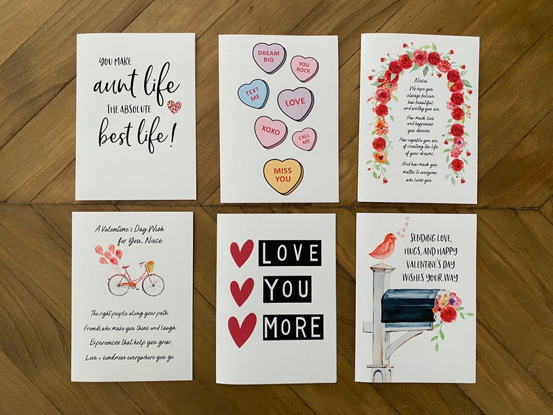 May include: Six different Valentine's Day cards with various designs and messages. The cards feature hearts, flowers, a bicycle, a bird, and a mailbox. The text on the cards includes "You make aunt life the absolute best life!" and "Love you more".