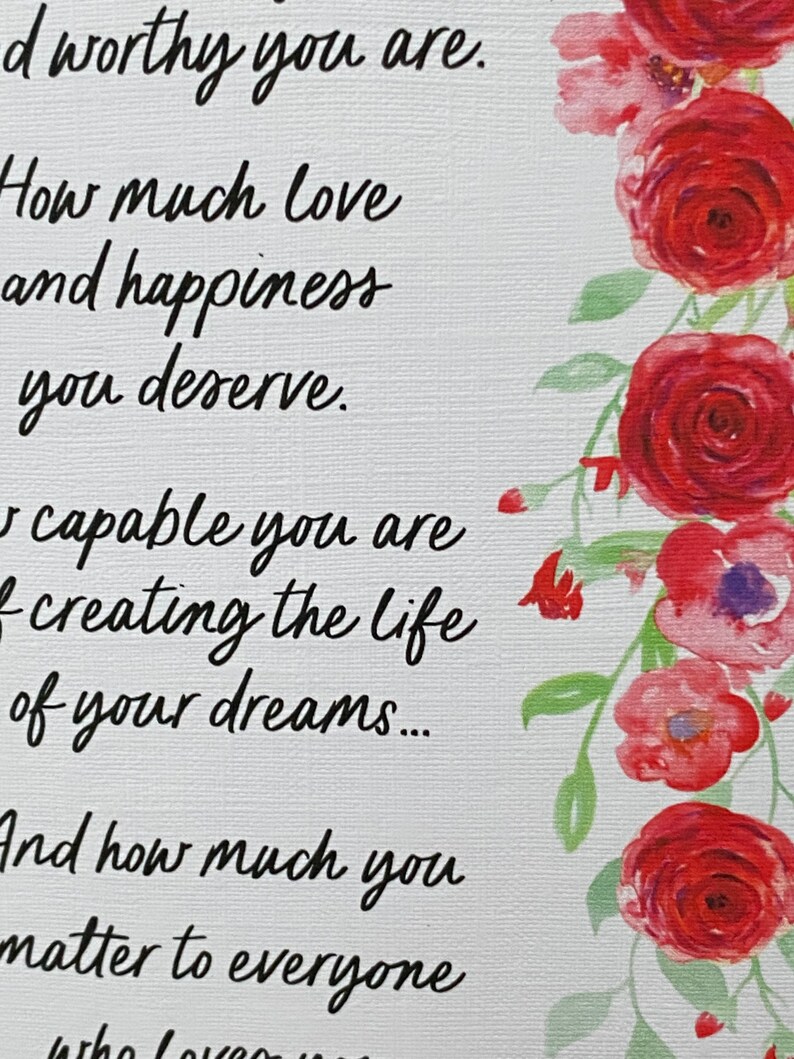 May include: A white card with a floral border of red and pink roses. The card has a handwritten message that reads: "You are worthy. How much love and happiness you deserve. You are capable of creating the life of your dreams... And how much you matter to everyone who loves you."