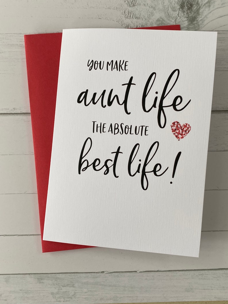 May include: A white card with black text that reads "You make aunt life the absolute best life!" with a red glitter heart.