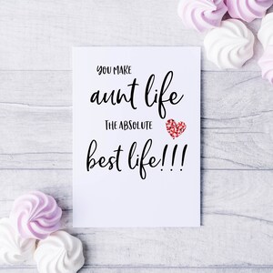 May include: White card with black text that reads "You make aunt life the absolute best life!!!" with a red glitter heart.