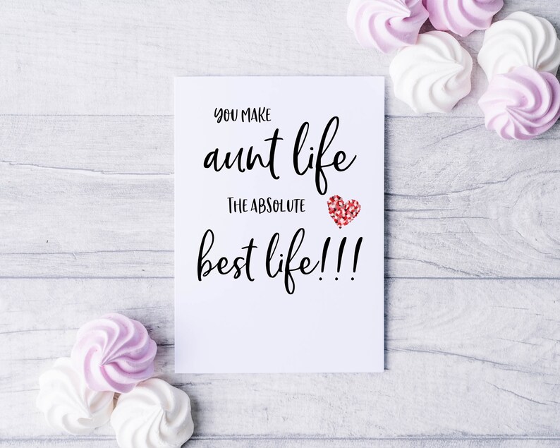 May include: White card with black text that reads "You make aunt life the absolute best life!!!" with a red glitter heart.