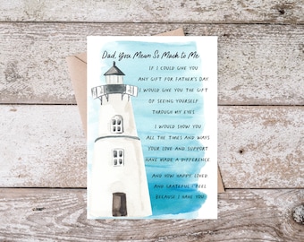 May include: A Father's Day card with a watercolor illustration of a white lighthouse against a blue sky. The card reads "Dad, You Mean So Much to Me" with a heartfelt message. The card is placed on a wooden surface.