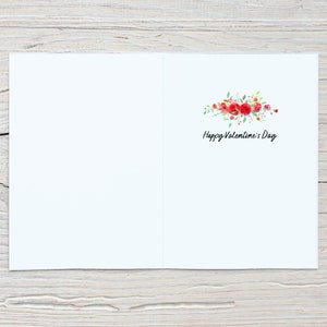 May include: A blank white card with a floral design and the text "Happy Valentine's Day" in black script.