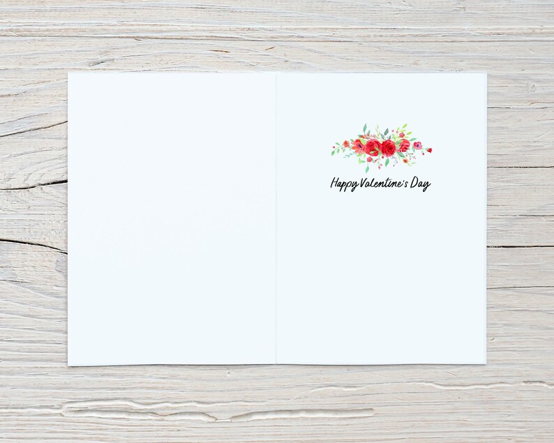 May include: A blank white card with a floral design and the text "Happy Valentine's Day" in black script.