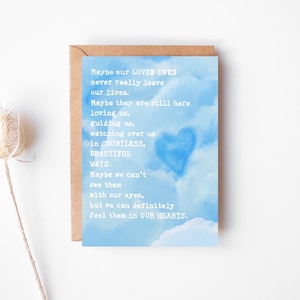 May include: A blue and white card with a heart-shaped cloud and a message about loved ones never truly leaving. The text reads: "Maybe our loved ones never really leave our lives. Maybe they are still here loving us, guiding us, watching over us in countless, beautiful ways. Maybe we can't see them with our eyes, but we can definitely feel them in our hearts."