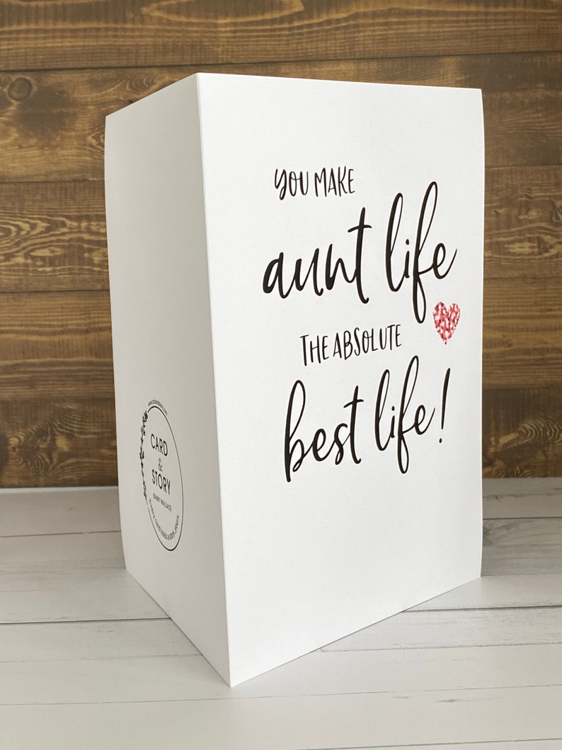May include: White card with black text that reads "You make aunt life the absolute best life!" with a red glitter heart.