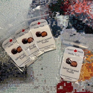 May include: Four small clear plastic bags with white labels. Each bag contains two chocolate truffles and a label that reads "CRAFT PACK Sticky Tack Salted Caramel Truffle *Do not eat & keep out of reach of children*"