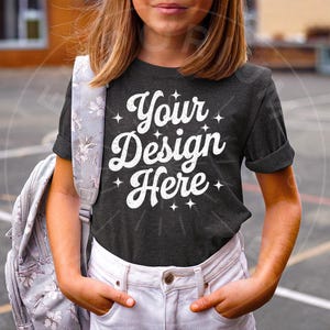 May include: A dark gray t-shirt with the text "Your Design Here" in white. The shirt has a distressed, vintage look and is decorated with small white stars.