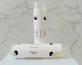 May include: Two white lip balm tubes with a coconut design and the text "Lip Balm COCONUT Made with real coconut".