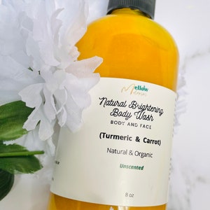 May include: A yellow plastic bottle of unscented natural brightening body wash with turmeric and carrot. The bottle is labeled "Mellow Dawn Natural Brightening Body Wash Body and Face (Turmeric & Carrot) Natural & Organic Unscented 8 oz."
