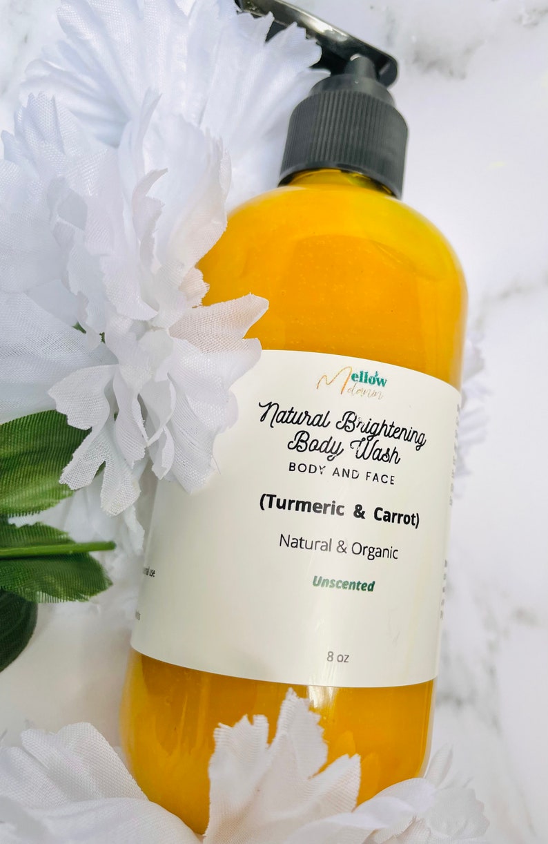 May include: A yellow plastic bottle of unscented natural brightening body wash with turmeric and carrot. The bottle is labeled "Mellow Dawn Natural Brightening Body Wash Body and Face (Turmeric & Carrot) Natural & Organic Unscented 8 oz."