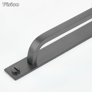 May include: A dark grey metal door pull with a curved handle and a rectangular base. The base has a single screw. The word "Vision" is in the upper left corner.