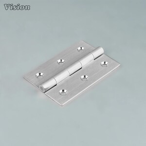 May include: A silver-colored hinge with a brushed metal finish. The hinge has a rectangular shape with rounded screw holes and a cylindrical pin connecting the two rectangular leaves. The word "Vision" is in the top left corner.