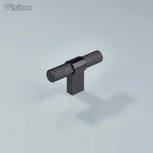 May include: A black cabinet knob with a textured, cylindrical handle and a rectangular base. The knob is made of metal and has a matte finish. The word "Vision" is in the top left corner.