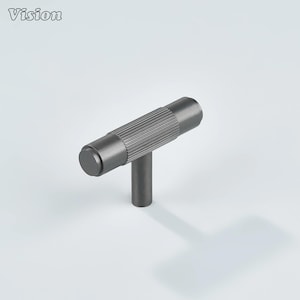 May include: A dark gray cabinet pull with a T-bar design. The horizontal bar has a ribbed texture, and the vertical stem is smooth. The word "Vision" is in the upper left corner.
