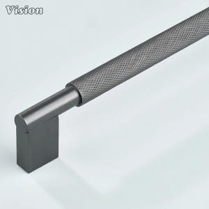 May include: A dark gray cabinet pull with a textured, diamond-patterned handle. The pull has a rectangular base and a cylindrical connecting piece. The word "Vision" is in the upper left corner.