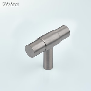 May include: A brushed nickel cabinet pull with a T-shaped design. The horizontal bar is cylindrical, and the vertical stem is also cylindrical. The word "Vision" is in the upper left corner.