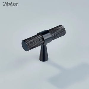 May include: Black cabinet pull with a diamond pattern on the handle. The pull has a cylindrical handle and a conical base. The word "Vision" is in the upper left corner. The hardware is made of metal.