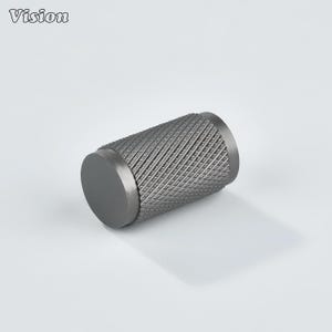 May include: A cylindrical, gunmetal-colored metal knob with a textured, diamond-patterned grip. The knob has a flat, circular end and the word "Vision" is in the upper left corner.