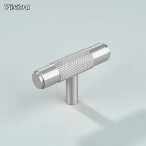 May include: A silver-colored T-bar cabinet pull with a cylindrical, ridged handle and a short, vertical post. The pull is made of metal and has a matte finish. The word "Vision" is in the top left corner.