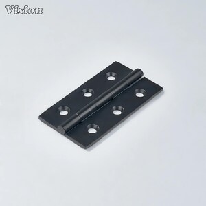 May include: A black hinge with six screw holes. The hinge is made of metal and has a cylindrical pin connecting the two rectangular plates. The word "Vision" is in the top left corner.