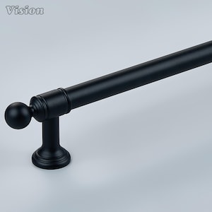 May include: A matte black cabinet handle featuring a cylindrical bar, a spherical finial at the end, and a sturdy mounting post with a circular base. The hardware has a smooth, uniform finish and a clean, functional design for furniture.