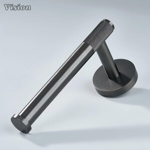 May include: A dark gray metal toilet paper holder. The holder has a textured grip on the end and a circular base. The word "Vision" is in the top left corner.