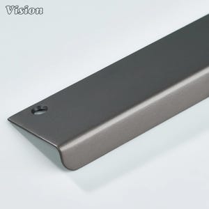 May include: A dark gray metal edge pull handle with a brushed finish and a single circular screw hole at the end. The hardware features a long, flat rectangular profile with a curved lip that extends downward, designed for cabinet or drawer mounting.