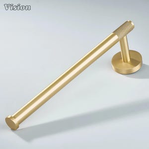 May include: A gold-colored towel bar with a circular base and a textured end. The bar is straight and cylindrical, with a smooth finish. The word "Vision" is in the top left corner.
