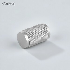 May include: A silver cabinet knob with a diamond-patterned grip. The cylindrical knob has a flat, circular end. The word "Vision" is in the top left corner.