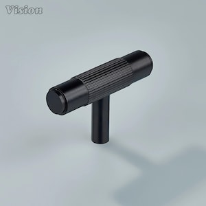 May include: A black T-shaped cabinet pull with a cylindrical, ridged handle and a solid, round end. The pull has a matte finish and a simple, modern design. The word "Vision" is in the top left corner.