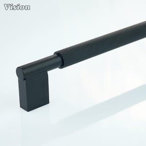 Peut inclure: Une poignée de meuble noire avec une poignée texturée à motif de losanges. La poignée a une base rectangulaire et une poignée cylindrique. Le mot "Vision" est dans le coin supérieur gauche.