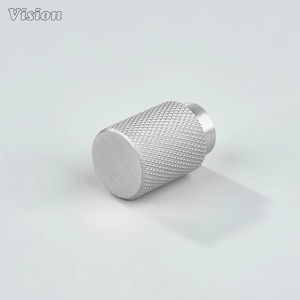 May include: A silver cylindrical knob with a textured, diamond-patterned grip. The knob has a flat, circular end and a smaller, cylindrical base. The word "Vision" is printed in the upper left corner.