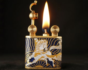 May include: A vintage lighter with a blue and gold enamel design featuring a white horse. The lighter has a brass body and a flame coming from the top.