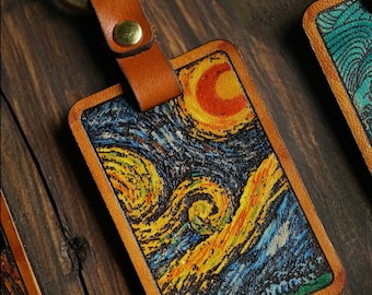 May include: A leather keychain with a brass ring and a rectangular leather tag featuring a printed image of Vincent van Gogh's "Starry Night" painting.