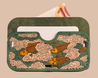 May include: Green leather cardholder with a hand-painted design of koi fish swimming through clouds. The wallet has a slot for cards and a pocket for cash. The design is in shades of gold, cream, and green.