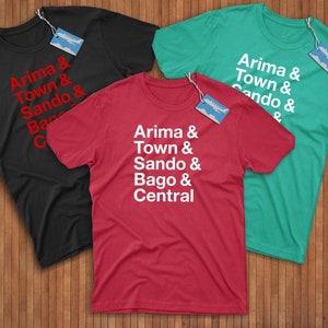 May include: Three t-shirts in different colours with text. The red t-shirt has white text that reads "Arima & Town & Sando & Bago & Central". The black t-shirt has red text that reads "Arima & Town & Sando & Bago & C". The green t-shirt has white text that reads "Arima & Town & Cando & ".