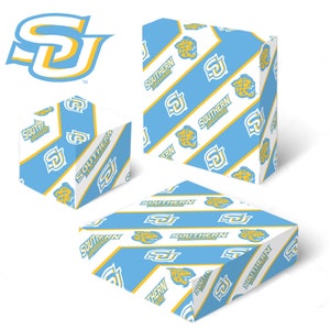 May include: Three gift boxes with a white background and a blue and yellow pattern. The pattern features the Southern Jaguars logo and a jaguar head. The boxes are different sizes.
