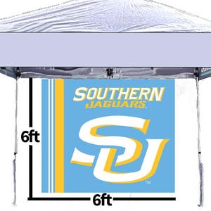 May include: A white pop-up canopy with a banner featuring the Southern Jaguars logo. The banner is 6ft x 6ft and displays the team name and logo in blue, gold, and white. The canopy is ideal for outdoor events.