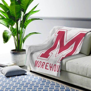 May include: White fleece throw blanket with a large red "M" and the text "Morehouse" in red.