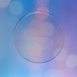 May include: A clear round cake board with the text "RIREANDCO 8.25 in." printed on it.