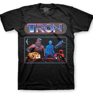 May include: Black t-shirt with a graphic of the Tron logo and characters from the movie. The logo is in a neon blue and pink color scheme with a grid pattern behind it. The characters are in a retro video game style.