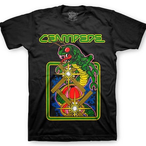 May include: Black t-shirt with a green centipede graphic and the text "CENTIPEDE" in green letters. The centipede is on a blue and yellow background with stars.