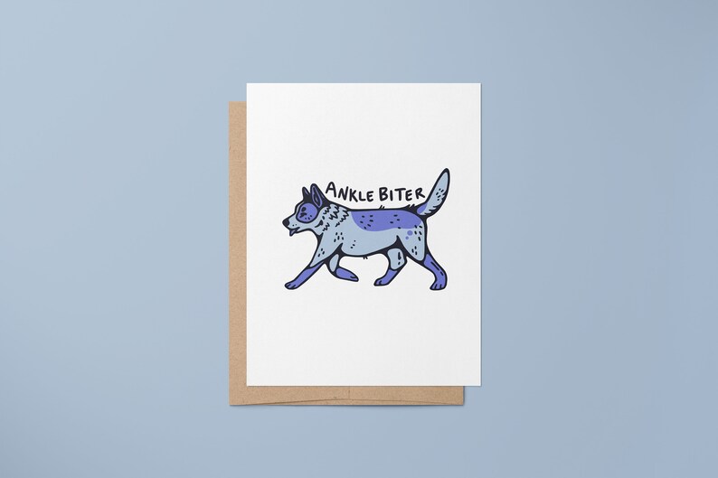 Puede incluir: Una tarjeta blanca con un perro de dibujos animados azul y morado caminando con el texto "ANKLE BITER" arriba.