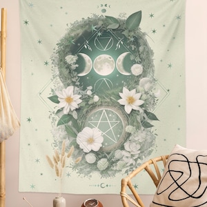 May include: A green and white tapestry with a floral design and a moon and star motif. The tapestry features a pentacle, a triple moon symbol, and a geometric design.