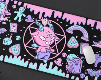May include: A black and pink mousepad with a cute cartoon demon, a rainbow, and other spooky and cute designs. The mousepad has a dripping effect with pink and blue colors.